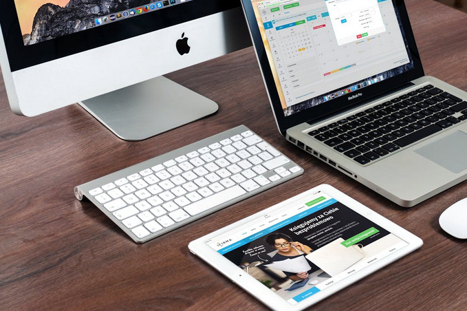 Professional workspace with Apple devices displaying our platform